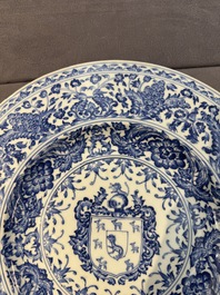 A large Chinese blue and white armorial dish with the arms of the Coelho family, Kangxi