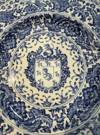 A large Chinese blue and white armorial dish with the arms of the Coelho family, Kangxi