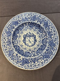 A large Chinese blue and white armorial dish with the arms of the Coelho family, Kangxi