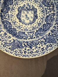 A large Chinese blue and white armorial dish with the arms of the Coelho family, Kangxi