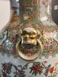 A pair of Chinese Canton famille rose vases and covers with narrative design, 19th C.