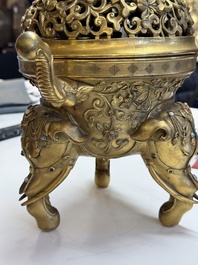 A large Chinese precious stone-inlaid gilt bronze 'elephant' tripod censer and cover on wooden stand, 19th C.