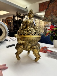 A large Chinese precious stone-inlaid gilt bronze 'elephant' tripod censer and cover on wooden stand, 19th C.