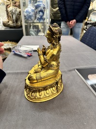 A Sino-Tibetan gilt bronze Virūpa, 19th C.