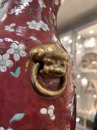 A pair of Chinese famille rose ruby-ground 'landscape' vases, 19th C.