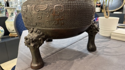 A large Chinese bronze archaistic 'taotie' tripod censer, 18th C.