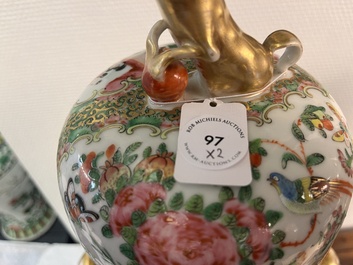 A pair of Chinese Canton famille rose vases and covers with narrative design, 19th C.