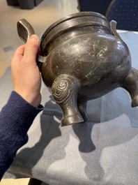 A Chinese bronze tripod censer with two handles, Ming