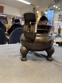 A Chinese bronze tripod censer with two handles, Ming