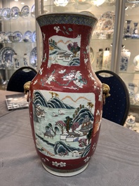A pair of Chinese famille rose ruby-ground 'landscape' vases, 19th C.