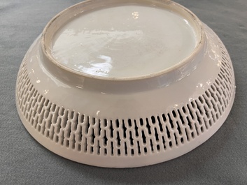 A Chinese famille rose 'mandarin subject' dish with a reticulated border, Qianlong