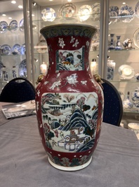 A pair of Chinese famille rose ruby-ground 'landscape' vases, 19th C.