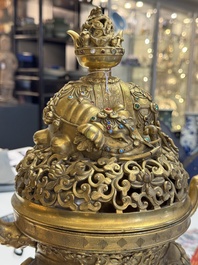 A large Chinese precious stone-inlaid gilt bronze 'elephant' tripod censer and cover on wooden stand, 19th C.