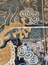A Chinese embroidered silk tapestry with a five-clawed dragon among clouds and bajixiang, 18/19th C.