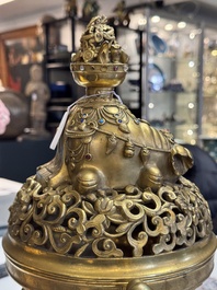 A large Chinese precious stone-inlaid gilt bronze 'elephant' tripod censer and cover on wooden stand, 19th C.