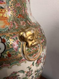 A pair of Chinese Canton famille rose vases and covers with narrative design, 19th C.