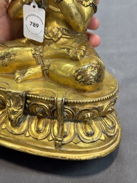 A Sino-Tibetan gilt bronze Virūpa, 19th C.
