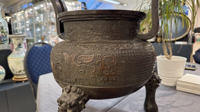 A large Chinese bronze archaistic 'taotie' tripod censer, 18th C.
