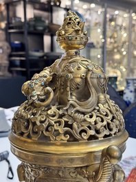 A large Chinese precious stone-inlaid gilt bronze 'elephant' tripod censer and cover on wooden stand, 19th C.