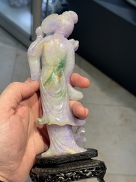 A Chinese lavender- and mint-green-jade figure of a goddess holding a sceptre and fan on wooden stand, 19th C.