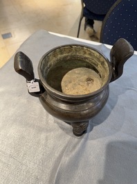 A Chinese bronze tripod censer with two handles, Ming