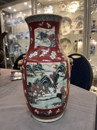 A pair of Chinese famille rose ruby-ground 'landscape' vases, 19th C.