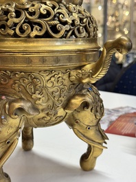 A large Chinese precious stone-inlaid gilt bronze 'elephant' tripod censer and cover on wooden stand, 19th C.