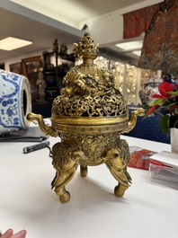A large Chinese precious stone-inlaid gilt bronze 'elephant' tripod censer and cover on wooden stand, 19th C.