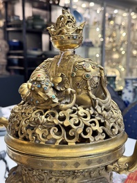 A large Chinese precious stone-inlaid gilt bronze 'elephant' tripod censer and cover on wooden stand, 19th C.