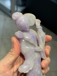 A Chinese lavender- and mint-green-jade figure of a goddess holding a sceptre and fan on wooden stand, 19th C.