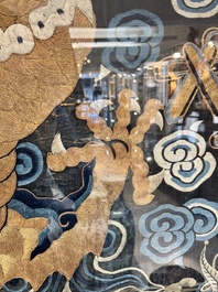 A Chinese embroidered silk tapestry with a five-clawed dragon among clouds and bajixiang, 18/19th C.