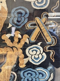 A Chinese embroidered silk tapestry with a five-clawed dragon among clouds and bajixiang, 18/19th C.