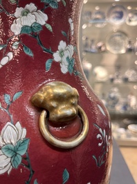 A pair of Chinese famille rose ruby-ground 'landscape' vases, 19th C.