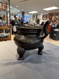 A Chinese bronze tripod censer with two handles, Ming