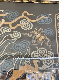 A Chinese embroidered silk tapestry with a five-clawed dragon among clouds and bajixiang, 18/19th C.