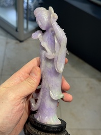 A Chinese lavender- and mint-green-jade figure of a goddess holding a sceptre and fan on wooden stand, 19th C.