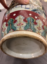 A pair of Chinese famille rose ruby-ground 'landscape' vases, 19th C.