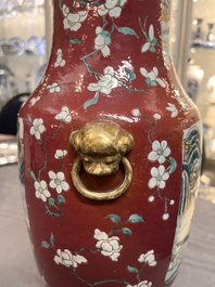 A pair of Chinese famille rose ruby-ground 'landscape' vases, 19th C.