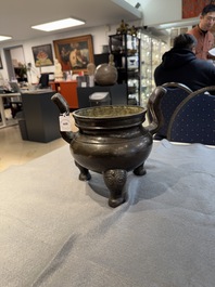 A Chinese bronze tripod censer with two handles, Ming