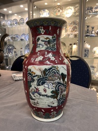 A pair of Chinese famille rose ruby-ground 'landscape' vases, 19th C.