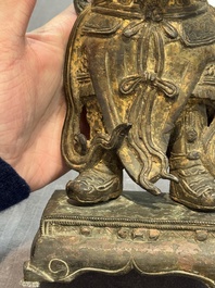 A pair of fine Chinese gilt bronze heavenly kings on stand, Ming