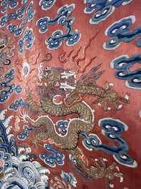 A fine Chinese gold thread embroidered red-ground silk noble lady&rsquo;s 'dragon' robe, 18/19th C.