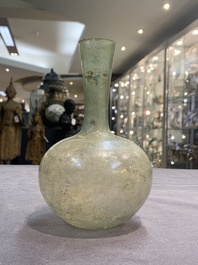A Roman glass bottle with a conical neck, 4/5th C.