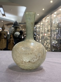 A Roman glass bottle with a conical neck, 4/5th C.