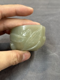 A Chinese jade peach-shaped brush washer on wooden stand, 19th C.