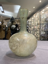 A Roman glass bottle with a conical neck, 4/5th C.