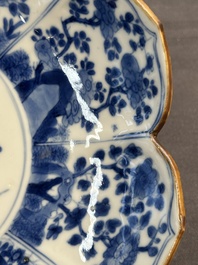 A pair of Chinese lotus-shaped blue and white plates with floral design, yu mark, Kangxi