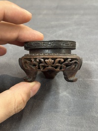 A Chinese jade peach-shaped brush washer on wooden stand, 19th C.