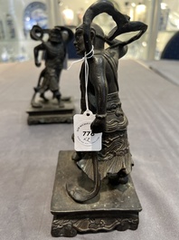 A pair of Chinese bronze guardians on stands, 17/18th C.