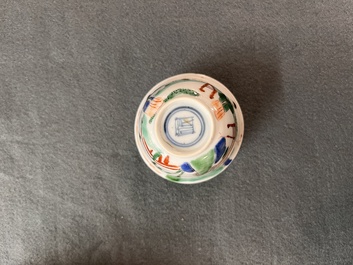 A Chinese famille verte ovoid tea caddy with floral design and a cup with figural design, Kangxi
